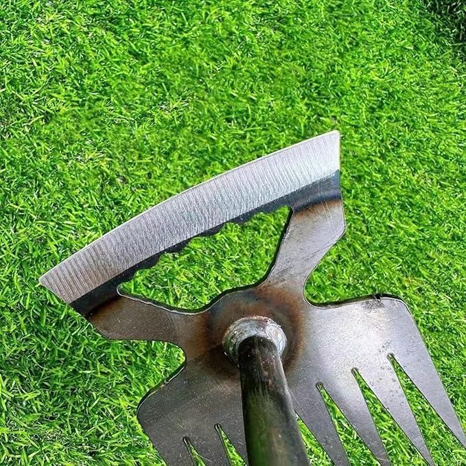 Metal garden rake on a grass background