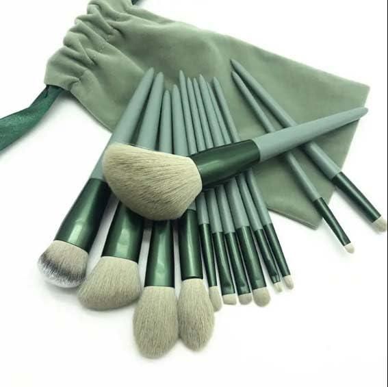 Set of green makeup brushes with a matching pouch on a white background