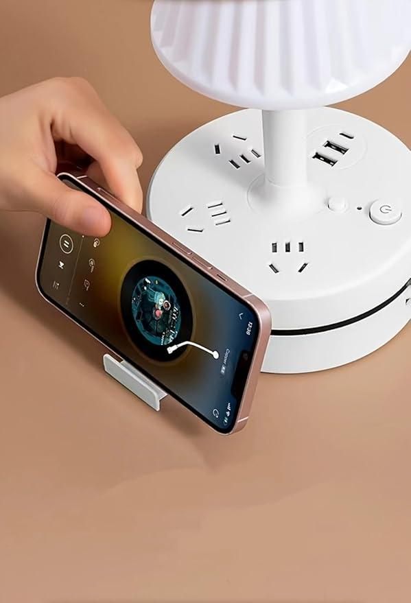 Hand using a smartphone to control a white lamp on a beige surface
