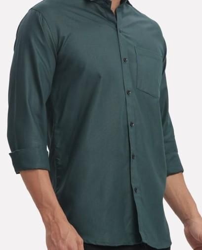 Green button-up shirt worn by a person on a white background