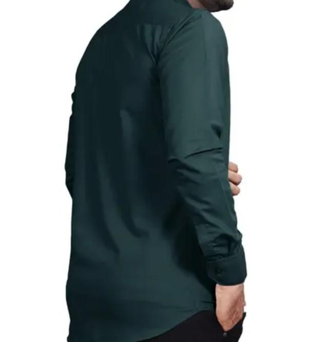 Person wearing a dark green long-sleeve shirt on a white background
