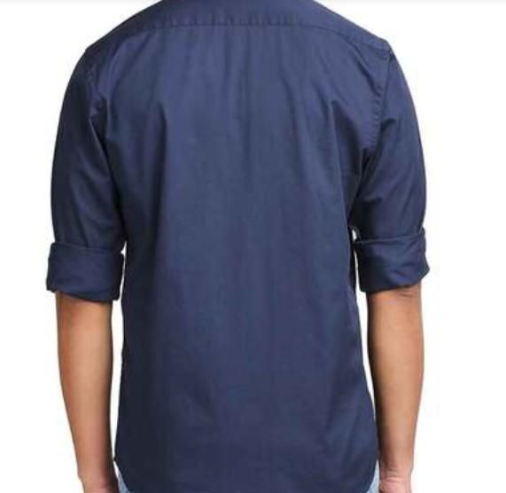 Navy blue shirt worn by a person on a white background