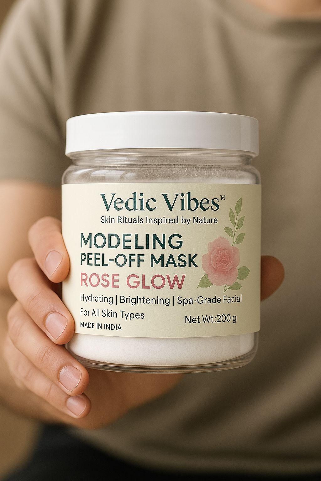 Jar of Vedic Vibes Modeling Peel-Off Mask held by a person with a blurred background