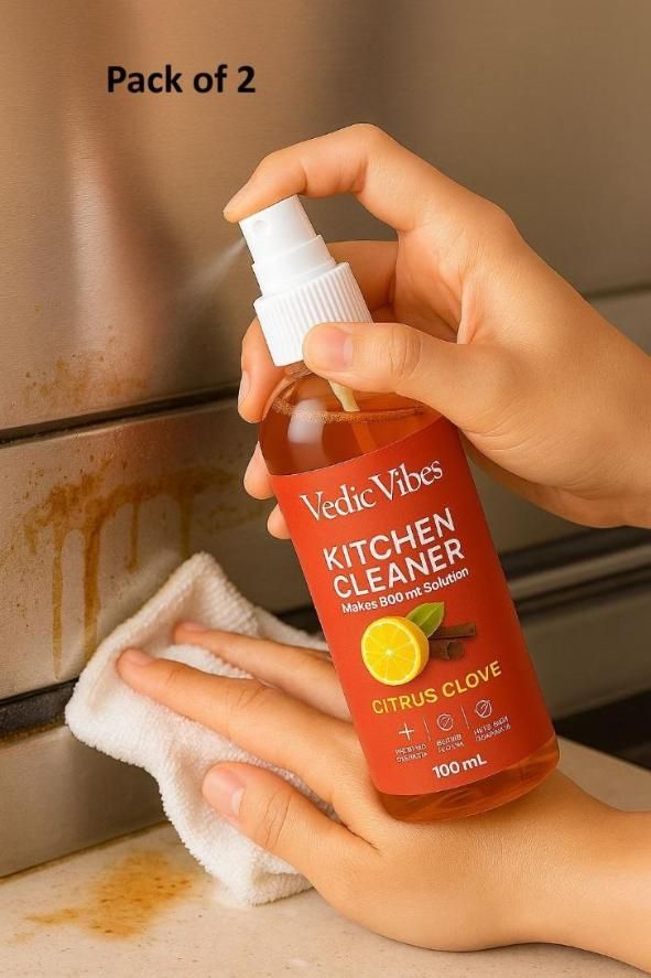Person using Vedic Vibes Kitchen Cleaner on a stained kitchen surface