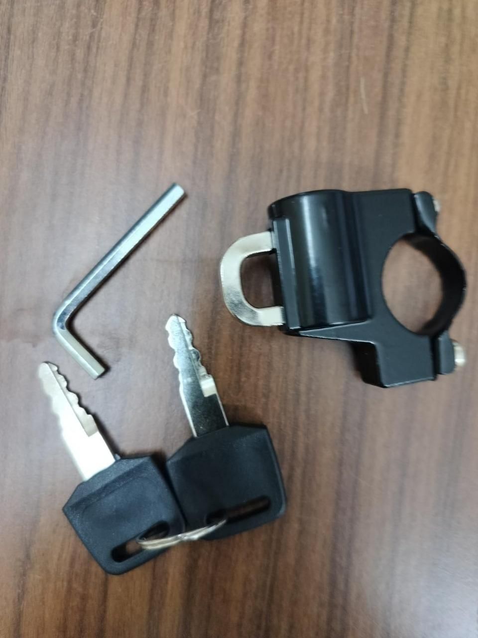 Anti-theft helmet lock for motorcycle and scooter handlebar