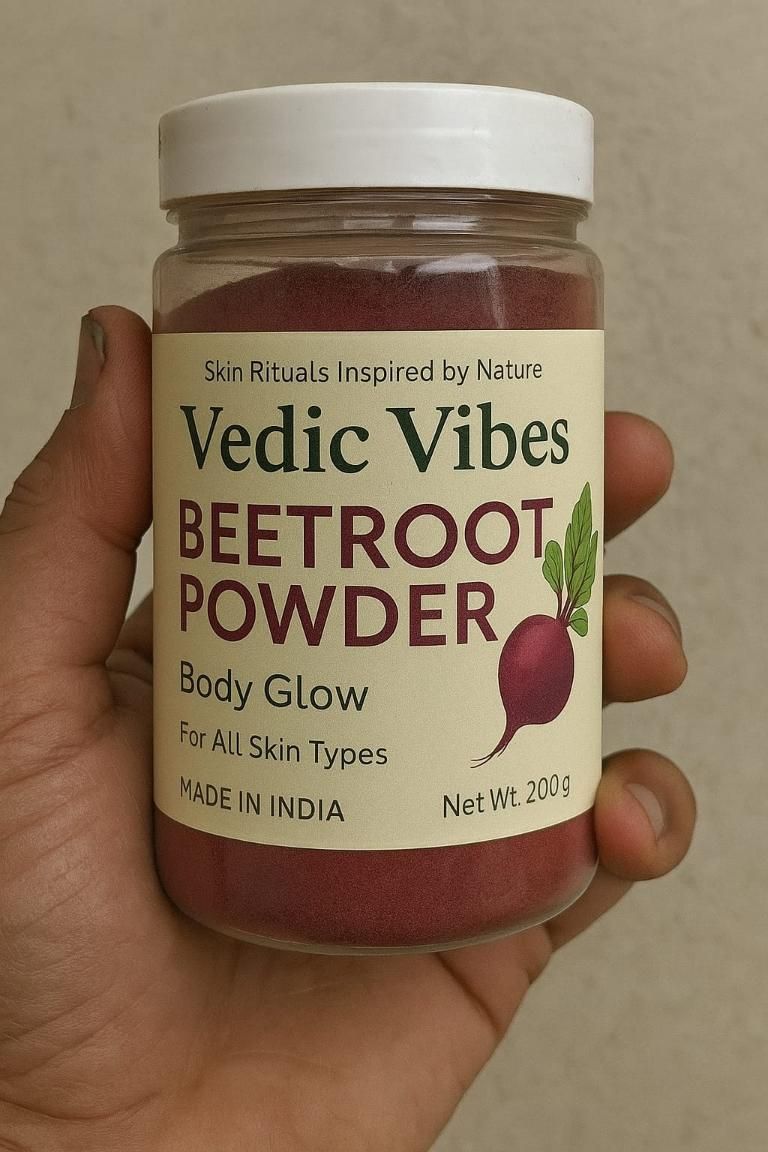 Jar of Vedic Vibes Beetroot Powder held by a hand against a neutral background