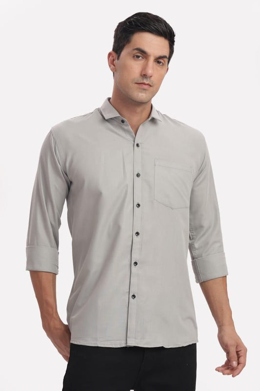 Man wearing a light gray button-up shirt on a white background