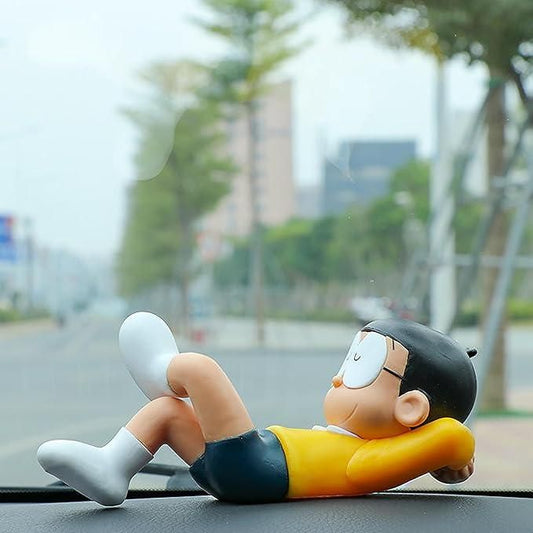 Cartoon character figurine relaxing on a car dashboard with a cityscape background