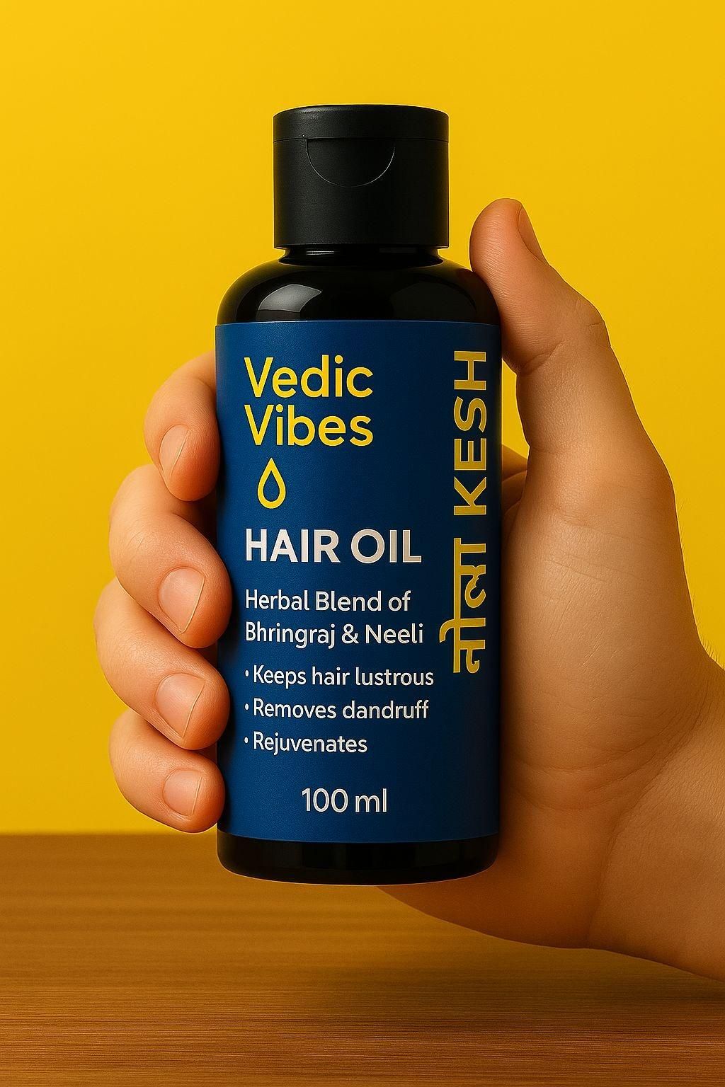 Hand holding a bottle of Vedic Vibes hair oil against a yellow background