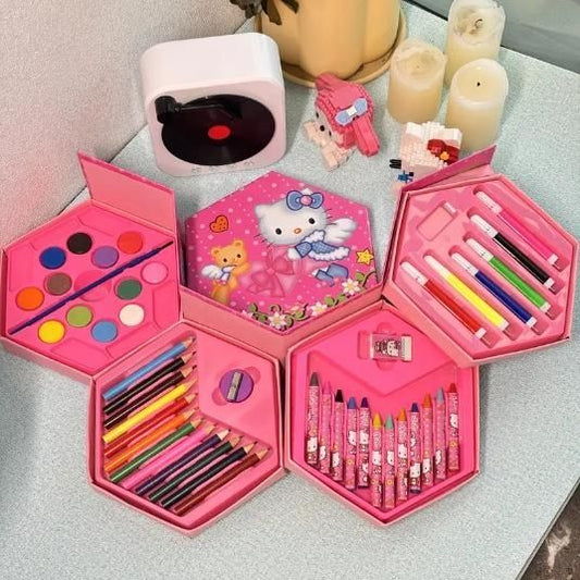 Pink children's art set with various art supplies on a light surface.