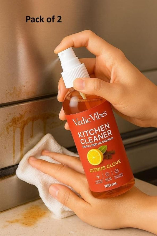 Person using Vedic Vibes Kitchen Cleaner on a stained kitchen surface