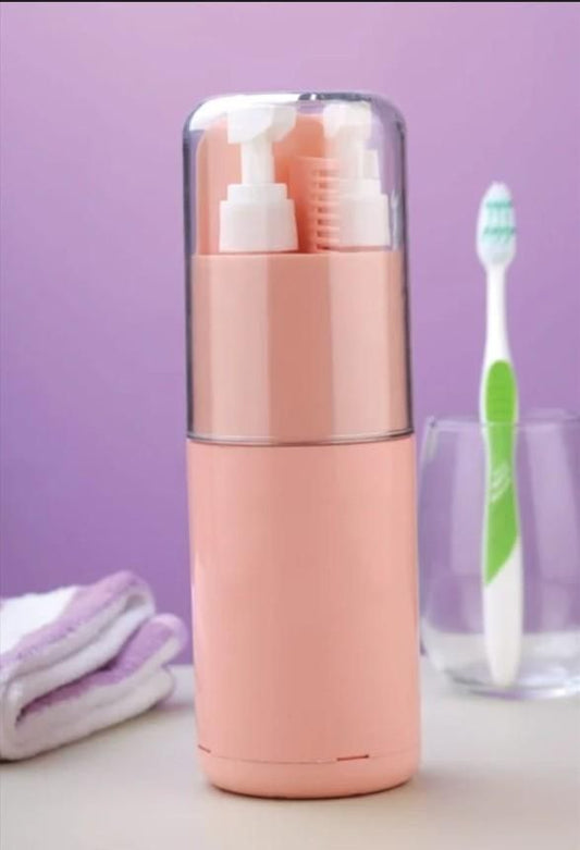 Pink travel-sized toiletry set with toothbrush and towel on a purple background