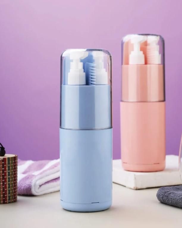 Two cosmetic bottles, one blue and one pink, on a surface with a purple background.